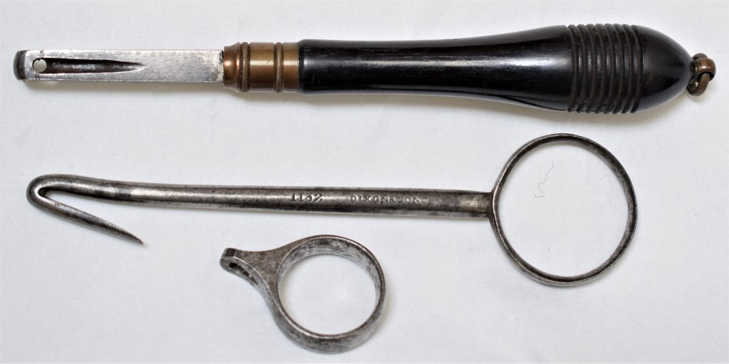 Three early simple pinfire extractors. From top to bottom: an ebony handled tool possible a copy of the early French pattern, a steel extractor stamped with the makers name Dixon & Sons and catalogue number 1132 and a ring extractor.n
